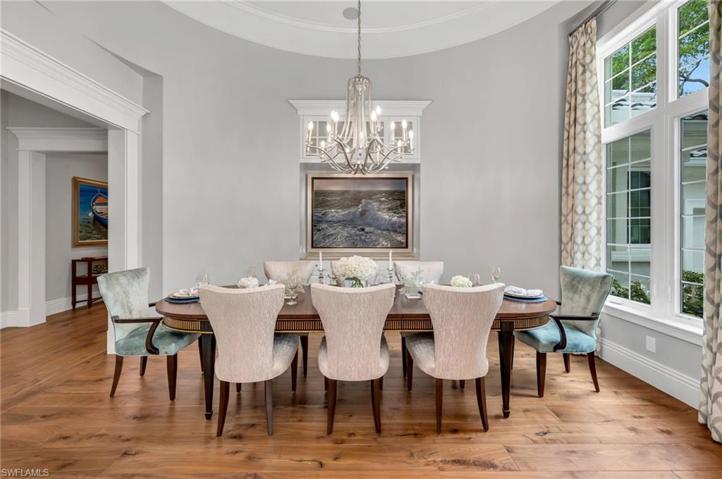 The oval-shaped dining room has a table that seats up to ten very comfortably, and is located just inside off the foyer.