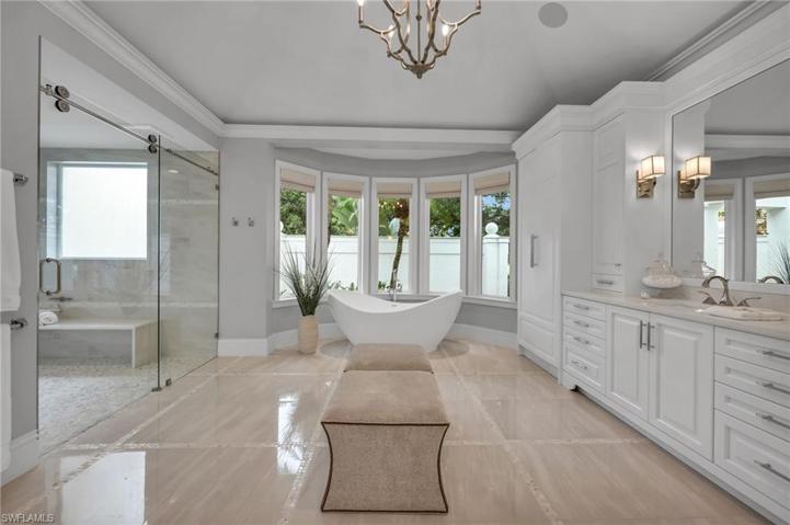 his bathroom was completely reimagined and thoughtfully designed, with abundant cabinetry, and polished nickel hardware throughout.  After a long day playing pickle ball, this bathtub looks quite inviting!