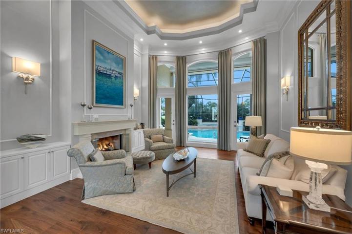The formal living room boasts of high ceilings, amazing views, millwork details, hardwood flooring and gas fireplace to add coziness.