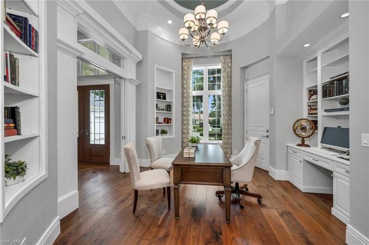 The office has beautiful hardwood floors, abundant shelving built-ins, high ceilings, and exquisite millwork.