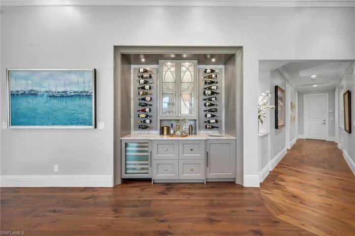 Long day...?  Ready for a glass of bubbly or cocktail?  This wet bar with it's custom design and wine refrigerator will house all your favorites...