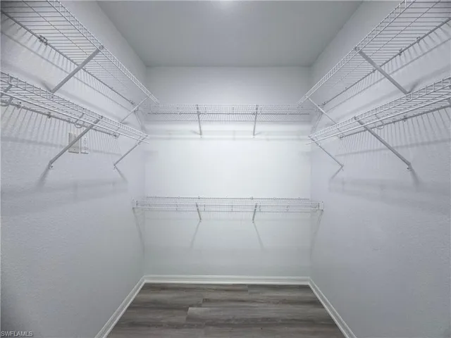 Walk in closet featuring hardwood / wood-style flooring