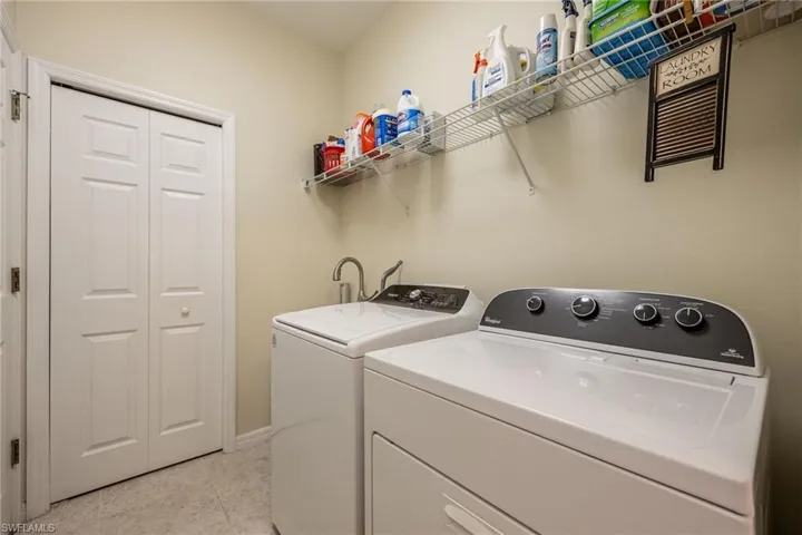 Laundry area with laundry tub, independent washer and dryer, and closet
