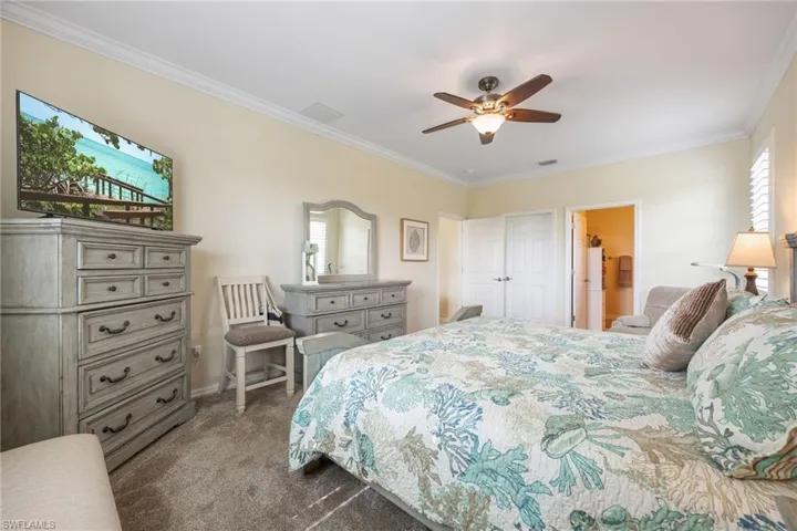 Primary ensuite bedroom with walk in closet and plantation shutters
