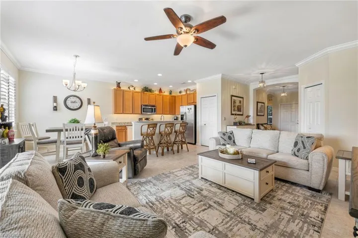 Living room with crown molding and open concept living