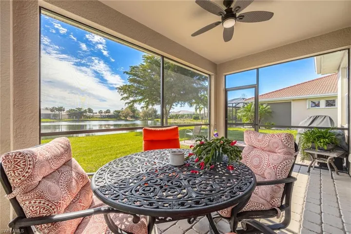 Screened lanai  featuring a ceiling fan, and a water view