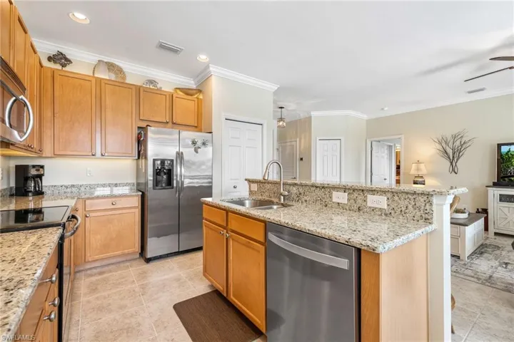 Kitchen featuring wood 42" upper cabinets and granite counters