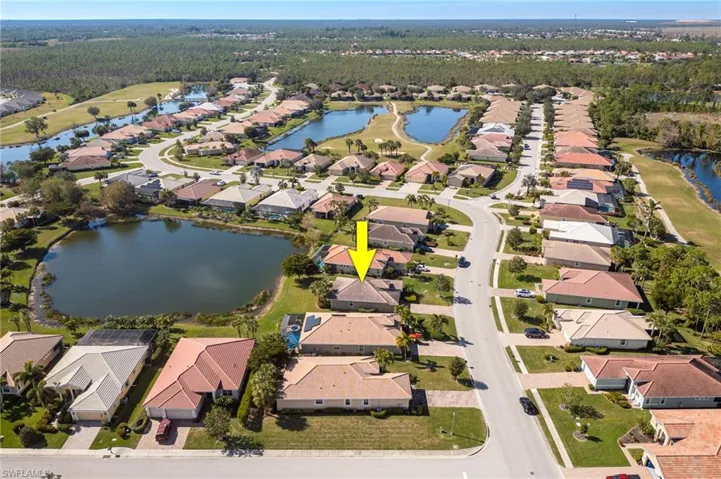 Birds eye view of property with a water view