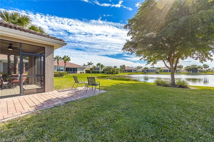 View of yard featuring an unobstructed water view, and a patio area perfect for grilling