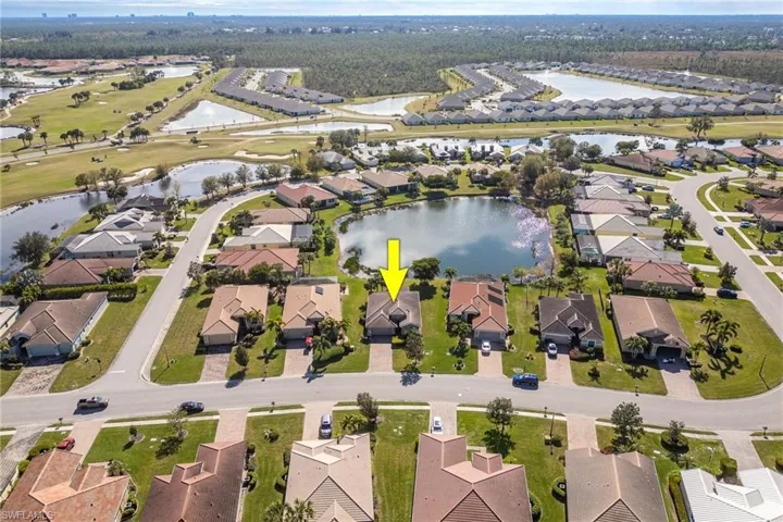 Birds eye view of property with a water view