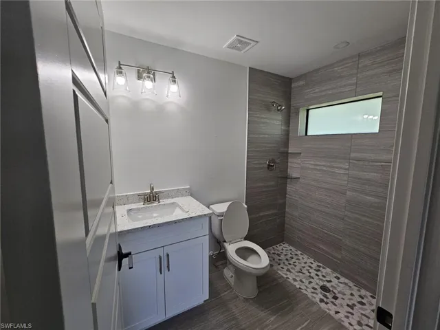 Bathroom featuring vanity and a stall shower