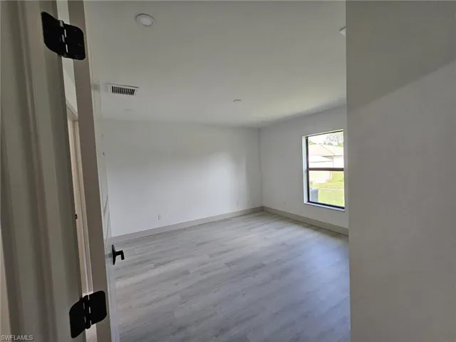 Spare room featuring light wood-style flooring and recessed lighting