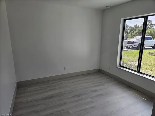 Empty room with light wood finished floors