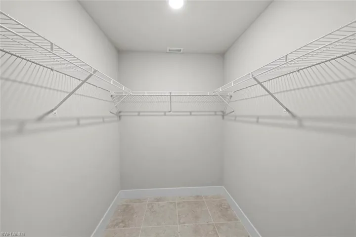 Walk in closet with tile patterned flooring