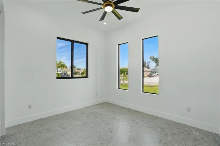Empty room with healthy amount of natural light, a ceiling fan, baseboards, and recessed lighting