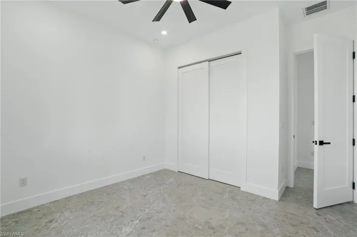 Unfurnished bedroom featuring a closet, recessed lighting, baseboards, and ceiling fan