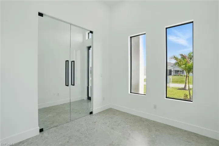 Unfurnished bedroom with baseboards, concrete floors, and a closet