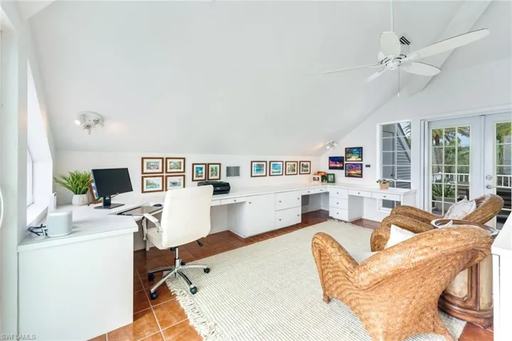 Office with vaulted ceiling, built in study area, french doors