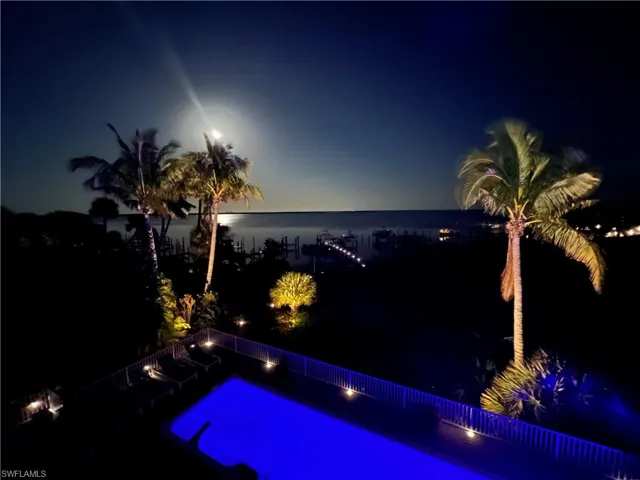 Pool at dusk with a water view