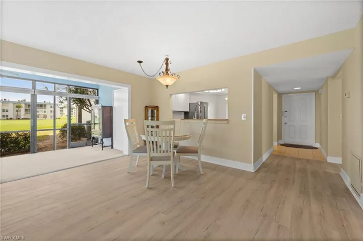 Light wood-finish flooring extending into the entry hall