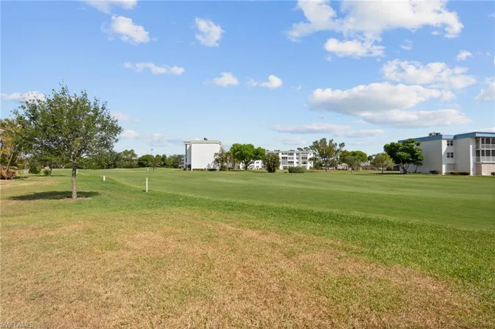 Expansive green space featuring manicured fairways and mature landscaping