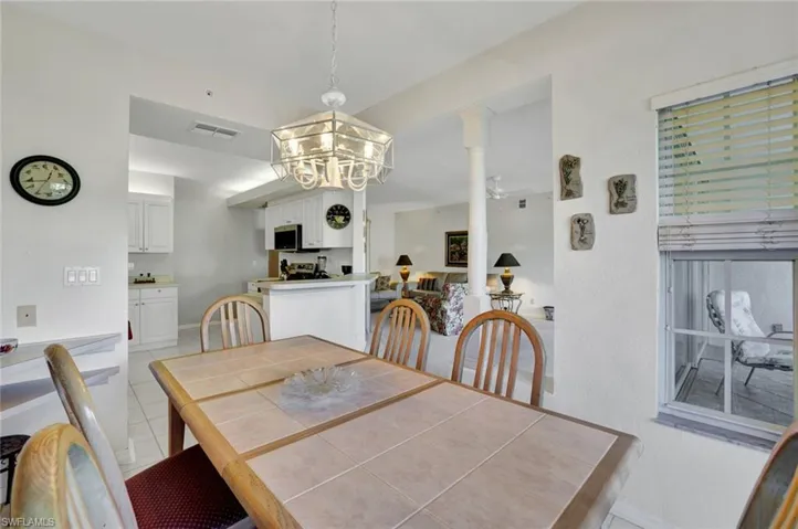 Dining area featuring light tile patterned floors and a chandelier