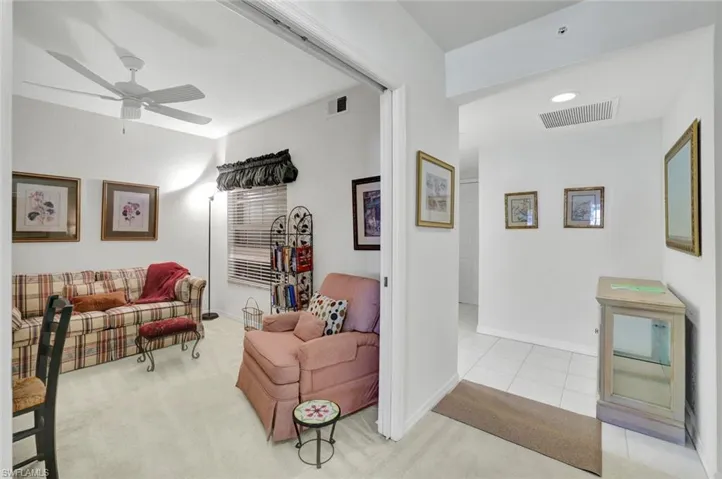 Living room featuring a ceiling fan and baseboards