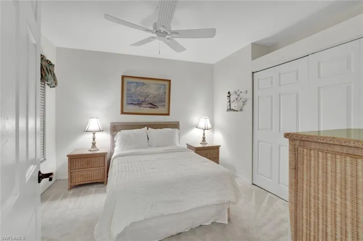 Bedroom featuring carpet flooring, a closet, and a ceiling fan