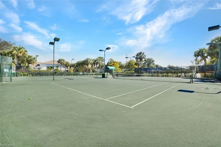 View of tennis court with community basketball court