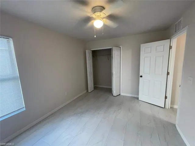 Unfurnished bedroom featuring ceiling fan and a closet