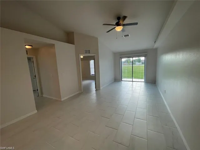 Spare room with ceiling fan and lofted ceiling