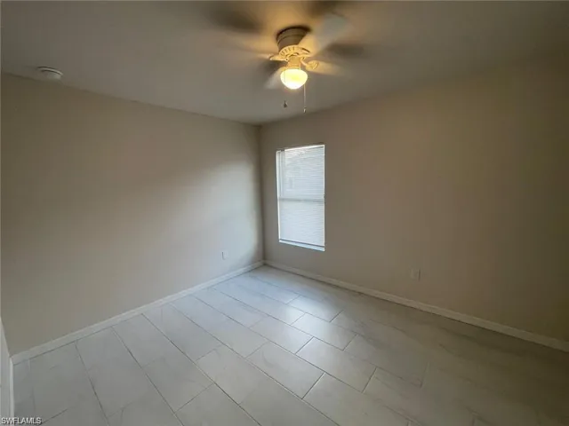 Spare room with ceiling fan