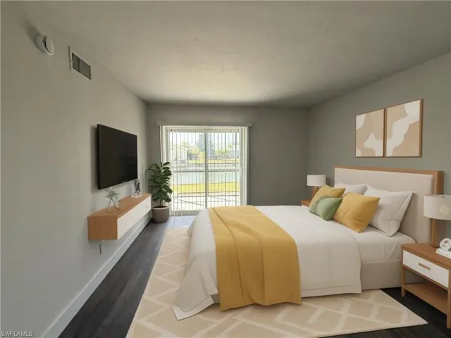 Bedroom with access to outside and wood finished floors