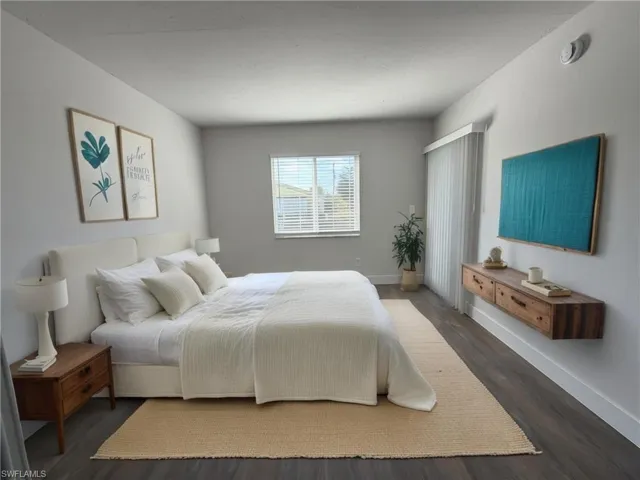 Bedroom featuring wood finished floors and baseboards