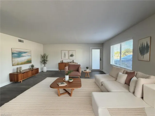 Living area with baseboards and wood finished floors