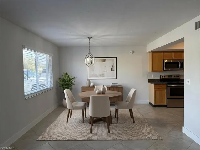 Dining room featuring baseboards and hanging lights