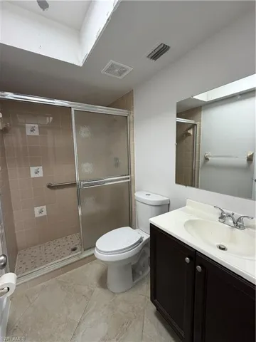 Bathroom featuring vanity and a stall shower