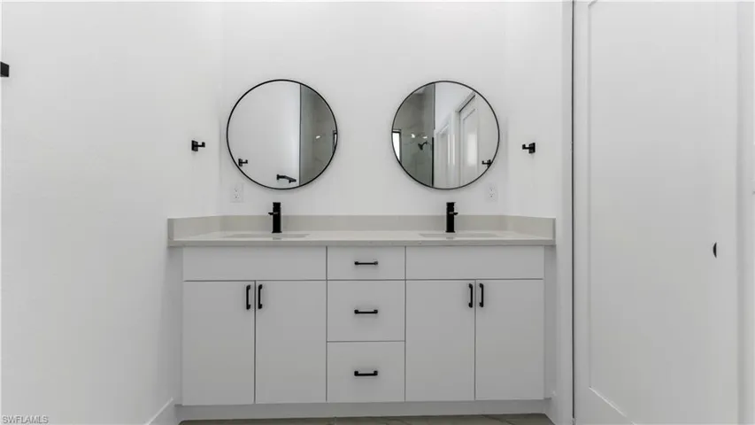 Primary bathroom featuring double vanity and a sink