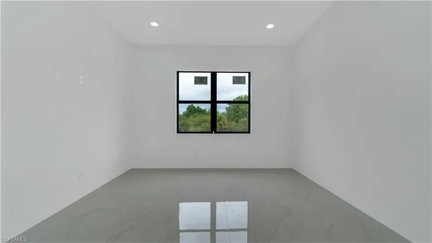 Primary bedroom featuring recessed lighting, porcelain tile floor