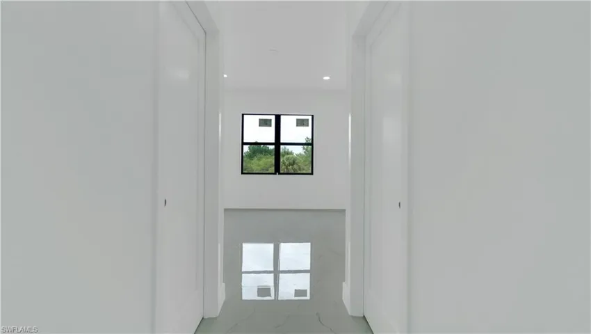 Primary bedroom hall with his and hers walk-in closets