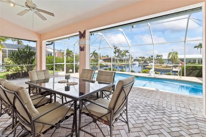 Water view featuring a dock and nearby suburban area