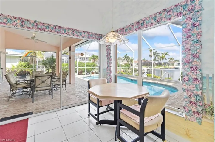 Living area featuring a ceiling fan, carpet flooring, and high vaulted ceiling