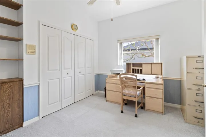 Spare room featuring carpet, a ceiling fan, a towering ceiling, and tile patterned floors