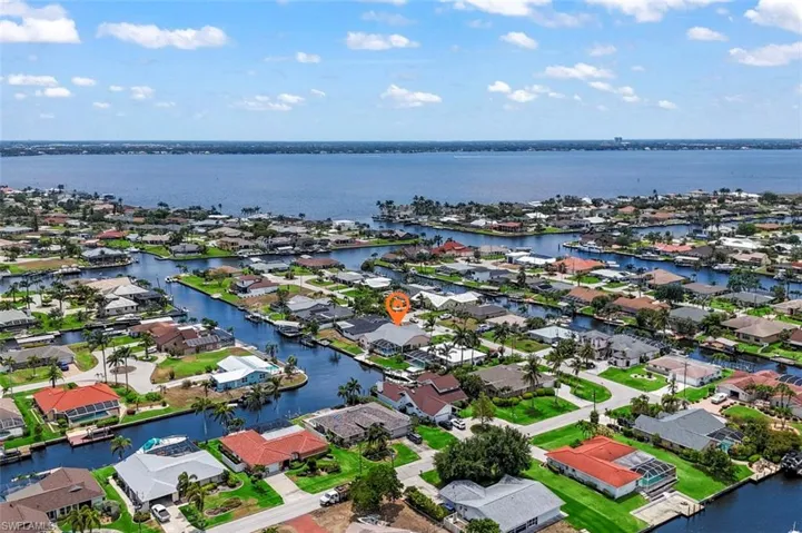 Aerial perspective of suburban area with a large body of water