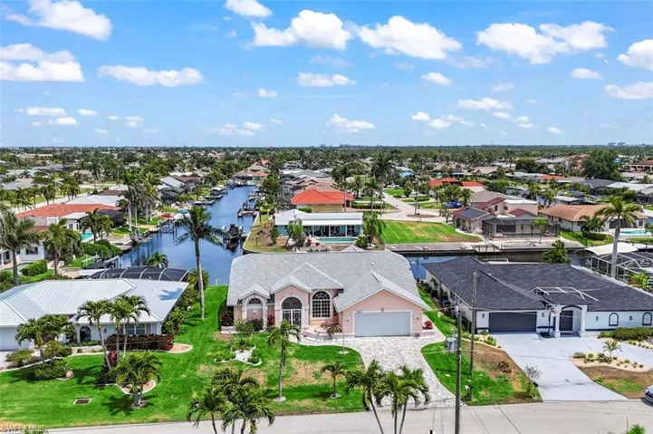 Aerial view of residential area featuring a large body of water