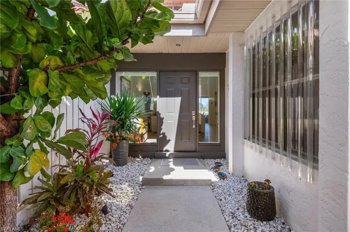 Front door entrance behind detached garage.