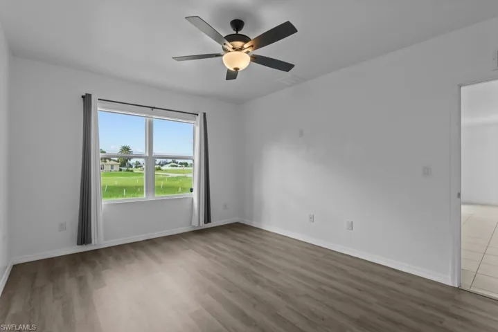 Unfurnished room with hardwood / wood-style flooring and ceiling fan