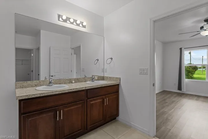 Bathroom with vanity, wood-type flooring, and ceiling fan