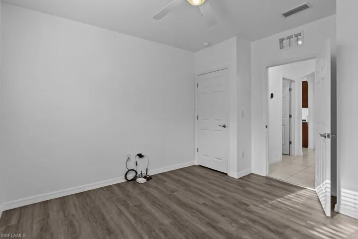 Unfurnished bedroom featuring light wood-type flooring and ceiling fan