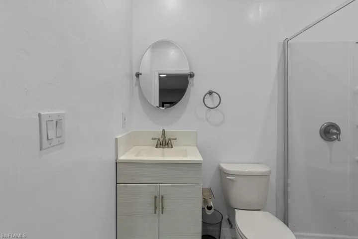 Bathroom with walk in shower, toilet, and vanity